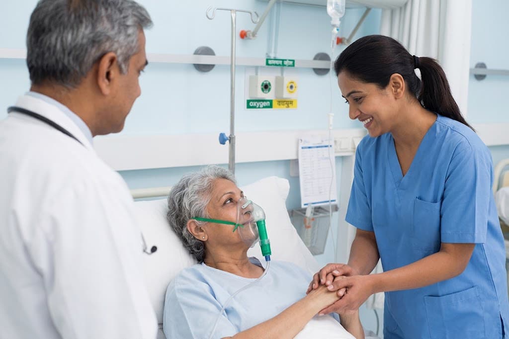 Doctor and nurse caring for an elderly patient on oxygen support